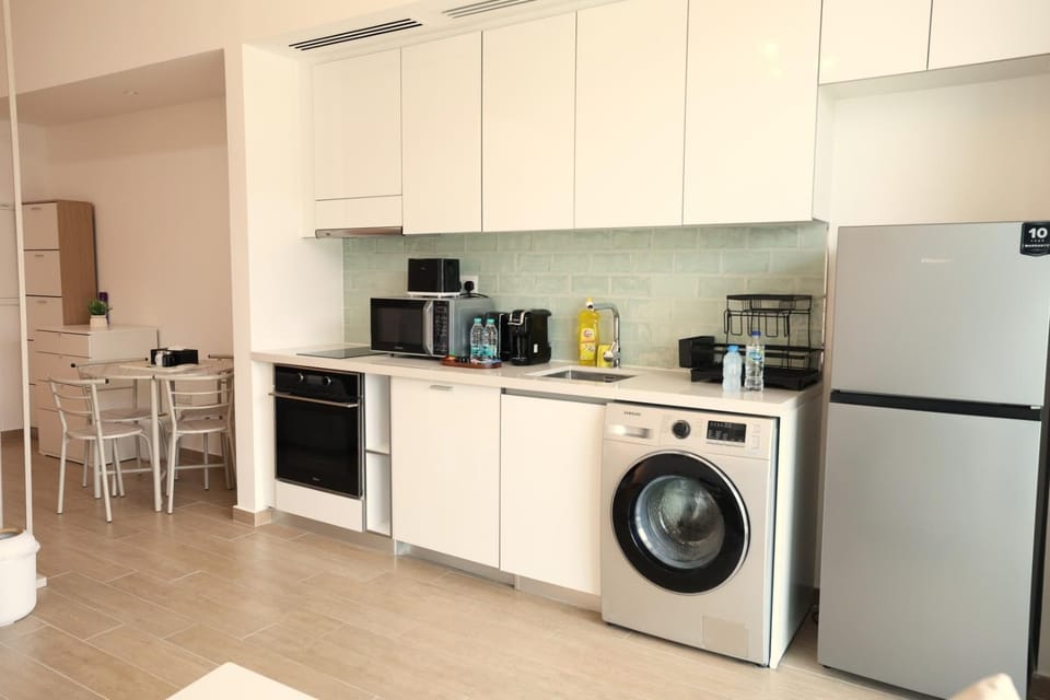 Kitchen or kitchenette, dishwasher, microwave, oven, stove, toaster, washing machine