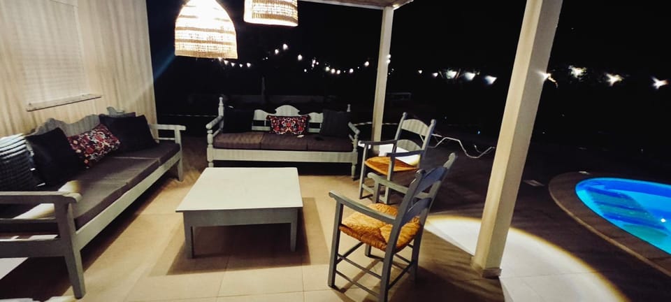 Night, Balcony/Terrace, Living room, Seating area, Pool view, Swimming pool