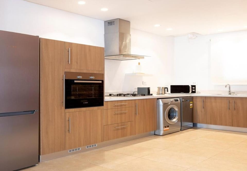 Kitchen or kitchenette, oven, stove, washing machine