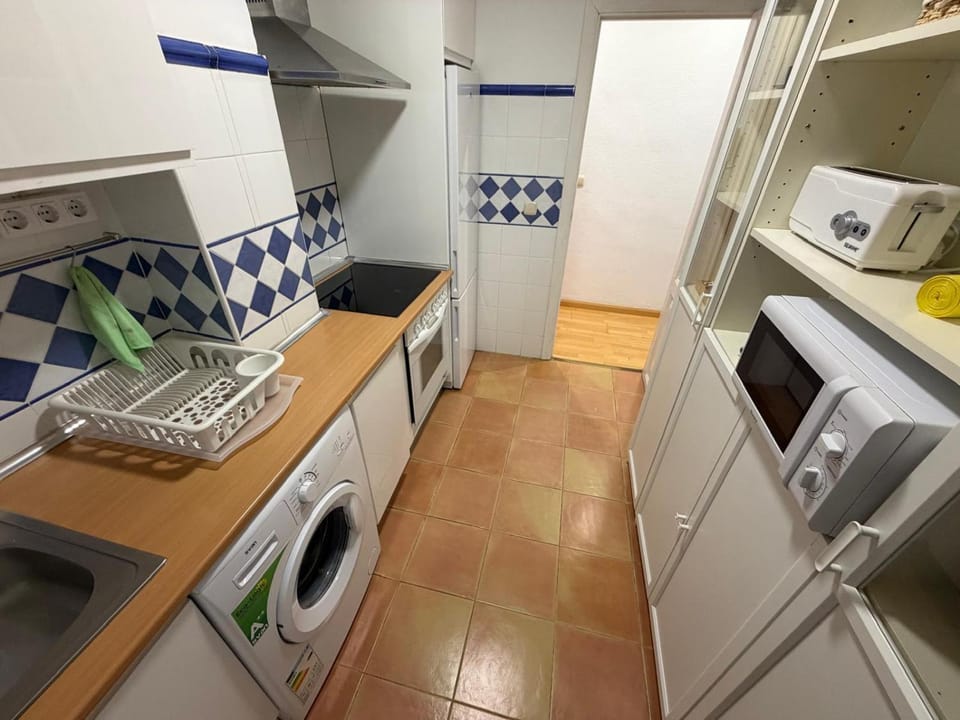 Kitchen or kitchenette, oven, stove, toaster, washing machine
