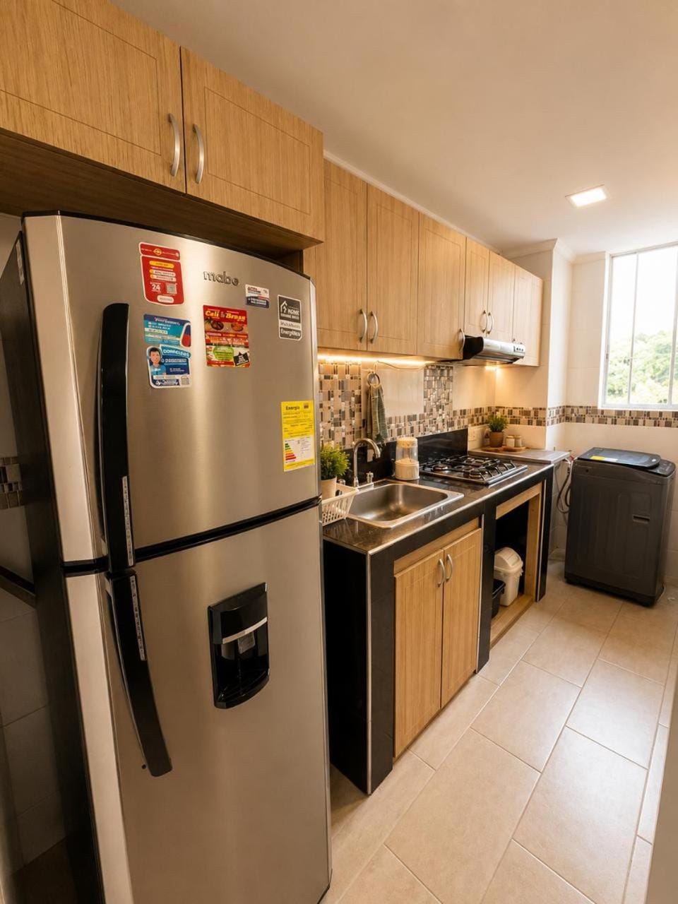 Kitchen or kitchenette, dishwasher, toaster, laundry, washing machine