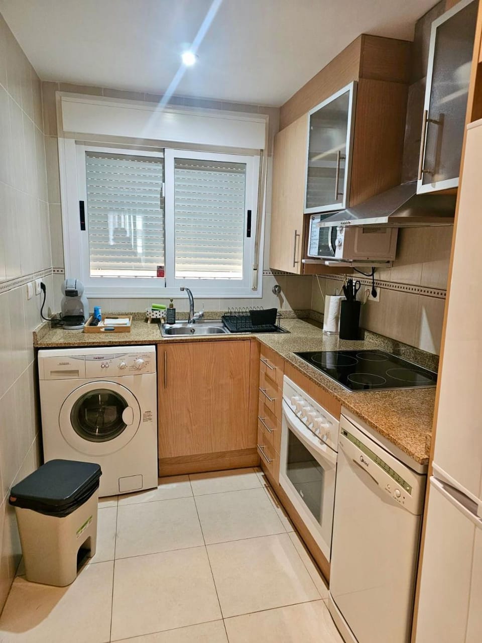 Kitchen or kitchenette, dishwasher, oven, stove