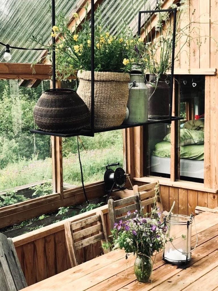 Old farmstead with log cabins by river at Lonin Cabin in Viken, Norway