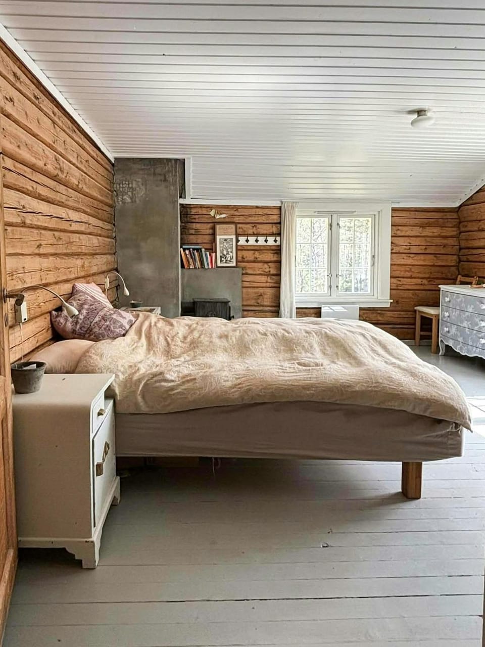Old farmstead with log cabins by river at Lonin Cabin in Viken, Norway