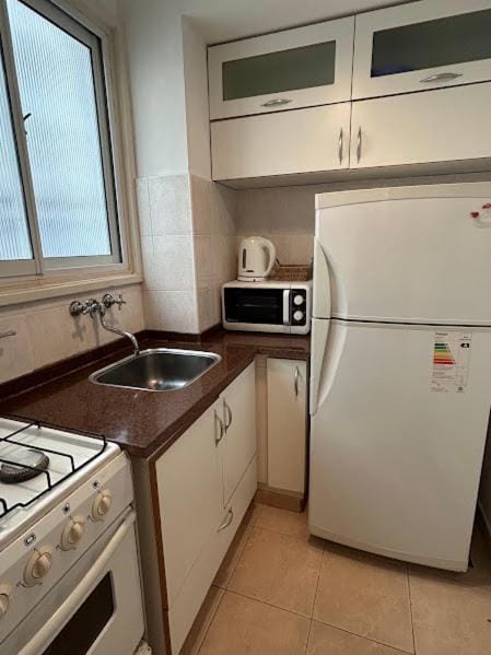 Kitchen or kitchenette, microwave, oven, stove, toaster