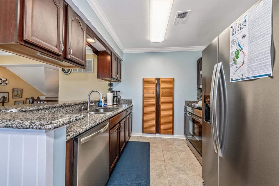 Kitchen or kitchenette, dishwasher, oven, stove