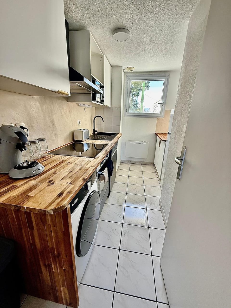 Kitchen or kitchenette, dishwasher, stove, toaster, washing machine
