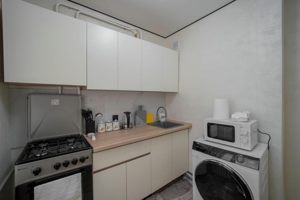 Kitchen or kitchenette, microwave, oven, washing machine