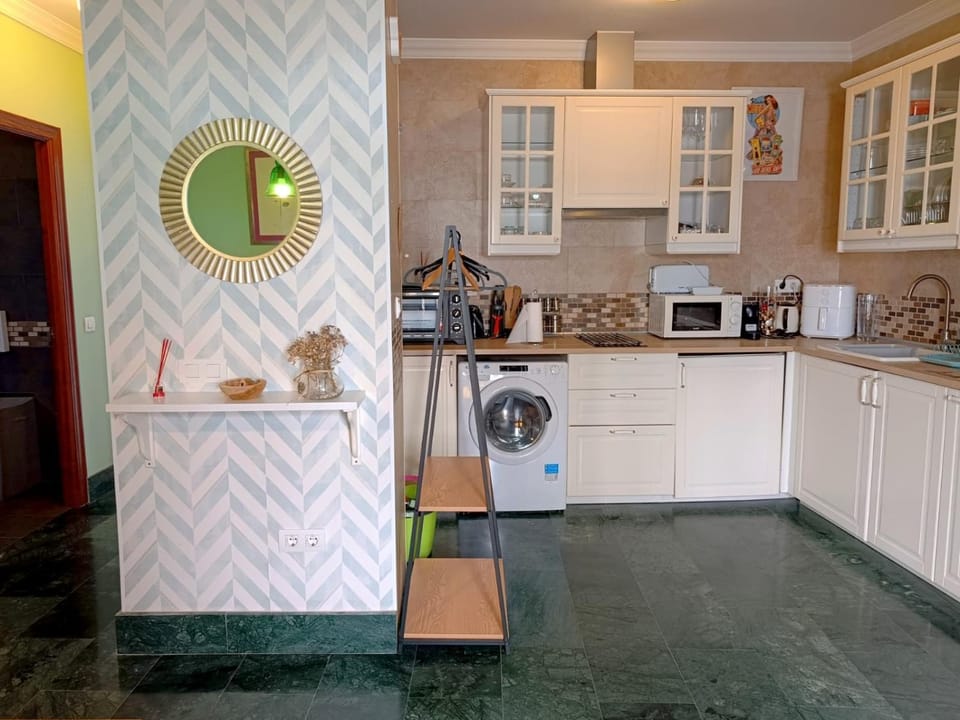 Kitchen or kitchenette, oven, stove, toaster, washing machine