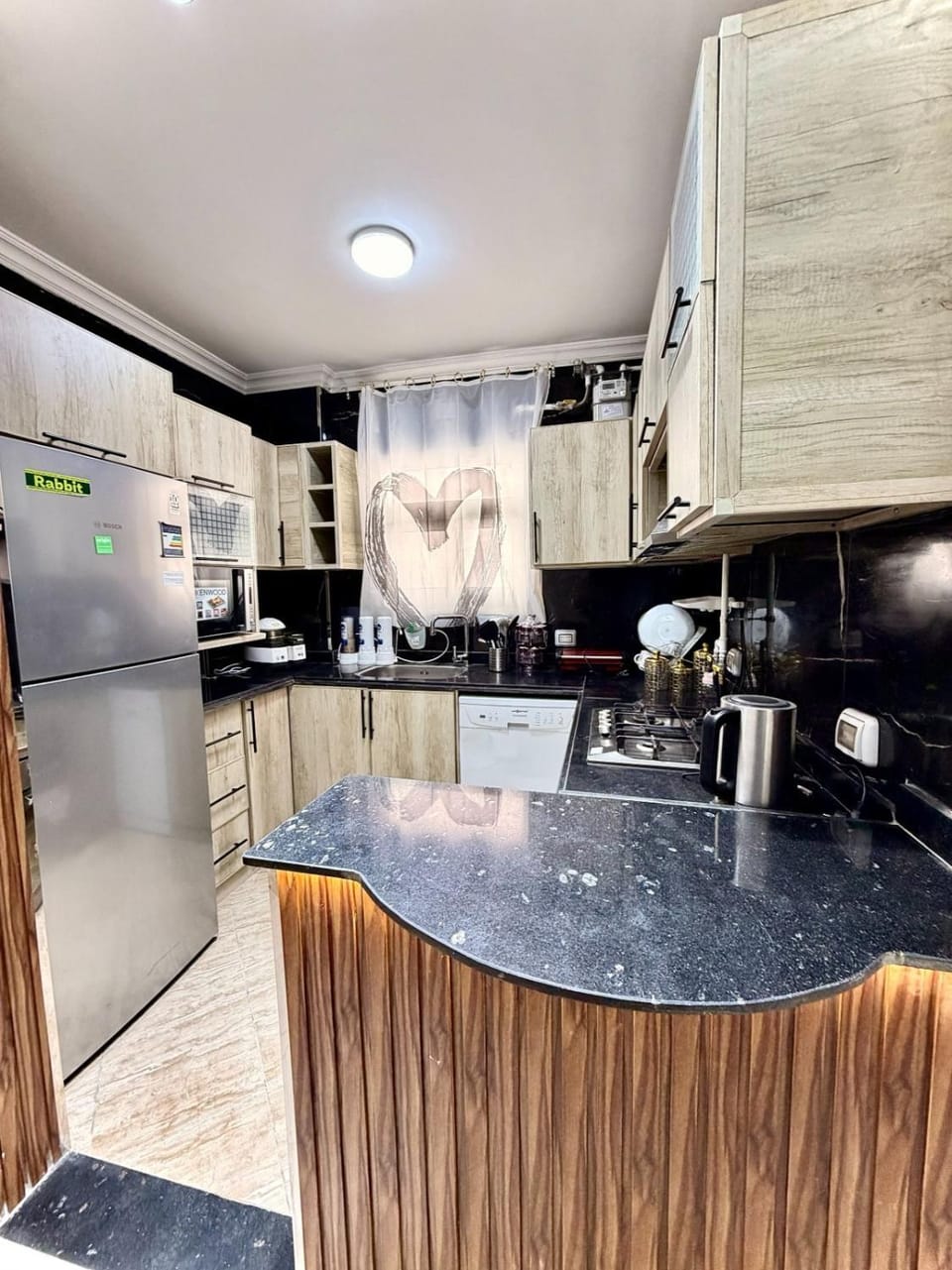 Kitchen or kitchenette, dishwasher, oven, stove