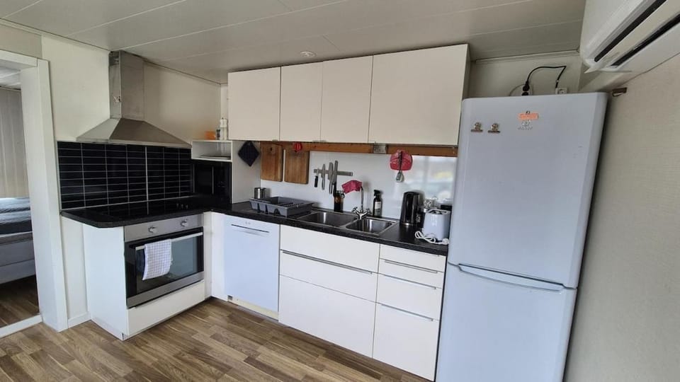 Kitchen or kitchenette, dishwasher, oven, stove