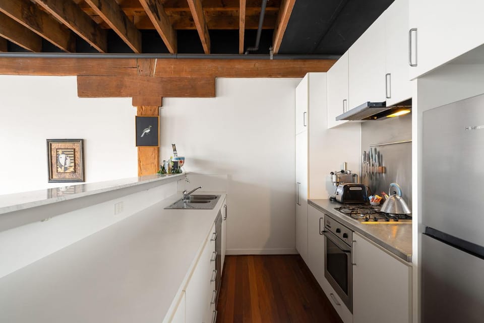 Kitchen or kitchenette, dishwasher, oven, stove