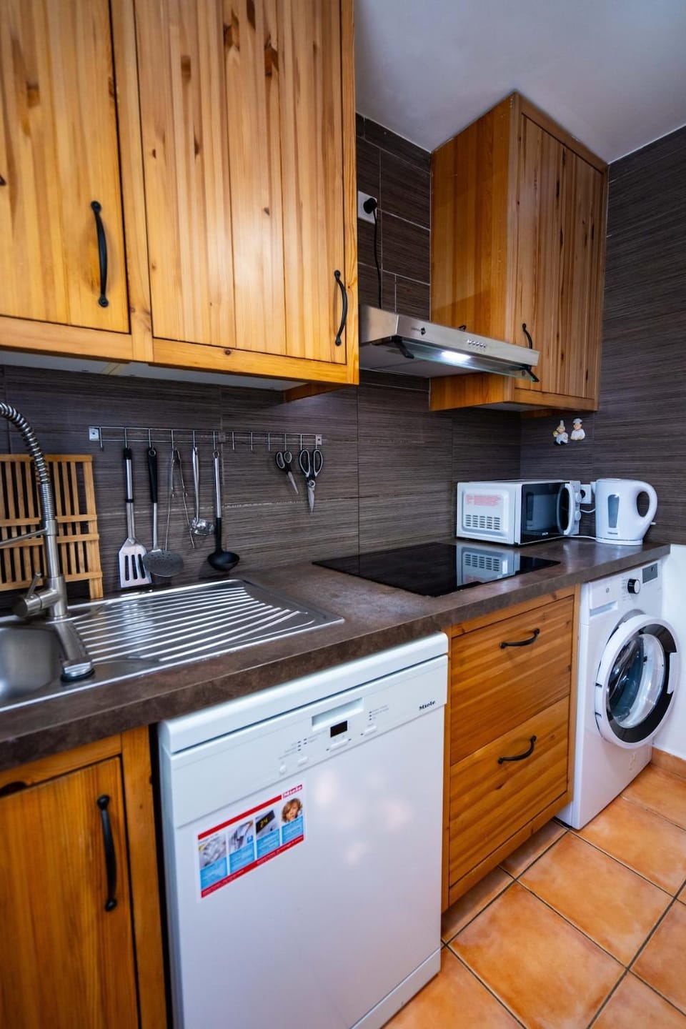 Kitchen or kitchenette, dishwasher, stove, washing machine