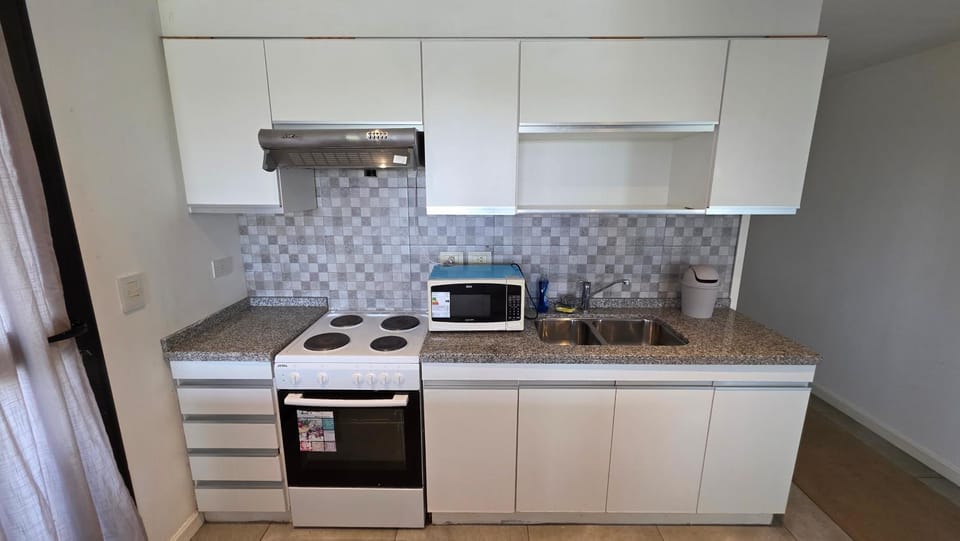 Kitchen or kitchenette, microwave, oven, stove