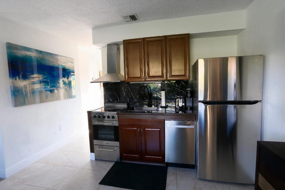 Kitchen or kitchenette, dishwasher, oven, stove