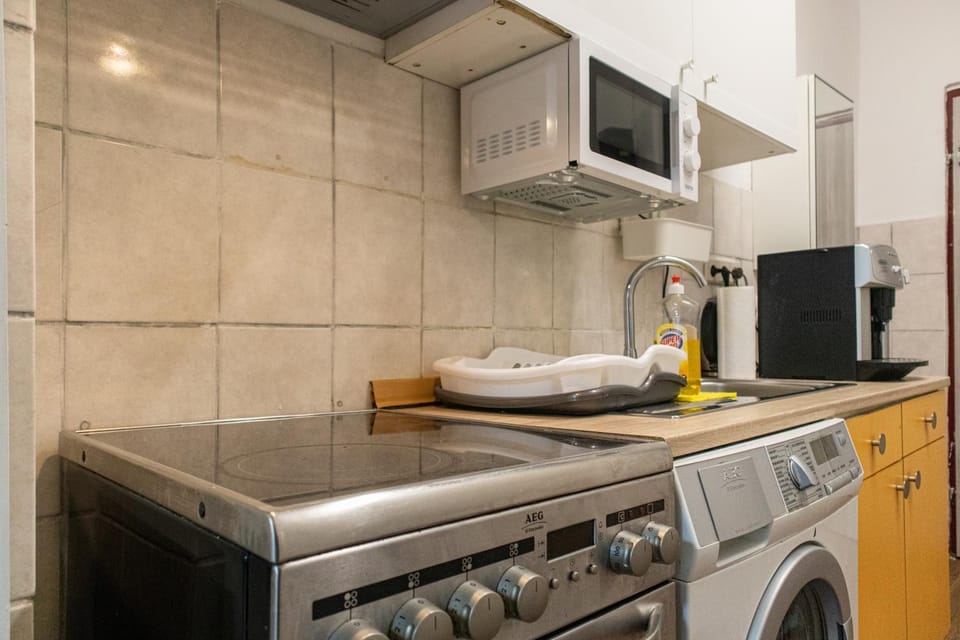 Kitchen or kitchenette, microwave, oven, stove, toaster, washing machine