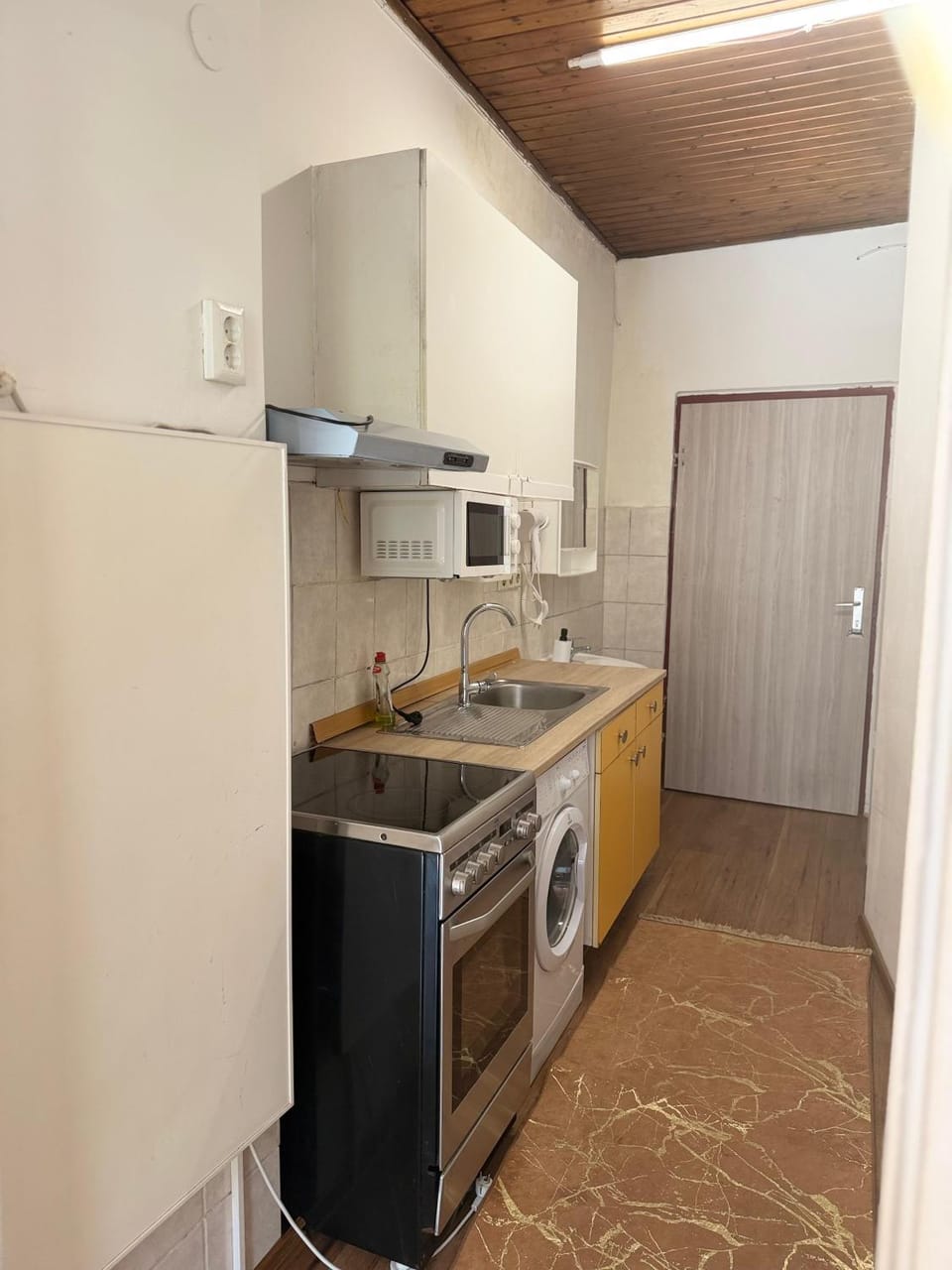 Kitchen or kitchenette, microwave, oven, stove, toaster, washing machine