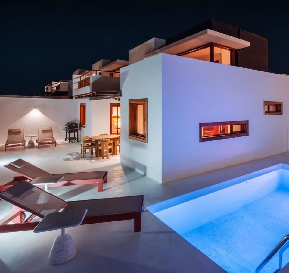 Property building, Patio, Night, Living room, Pool view, Swimming pool, sunbed