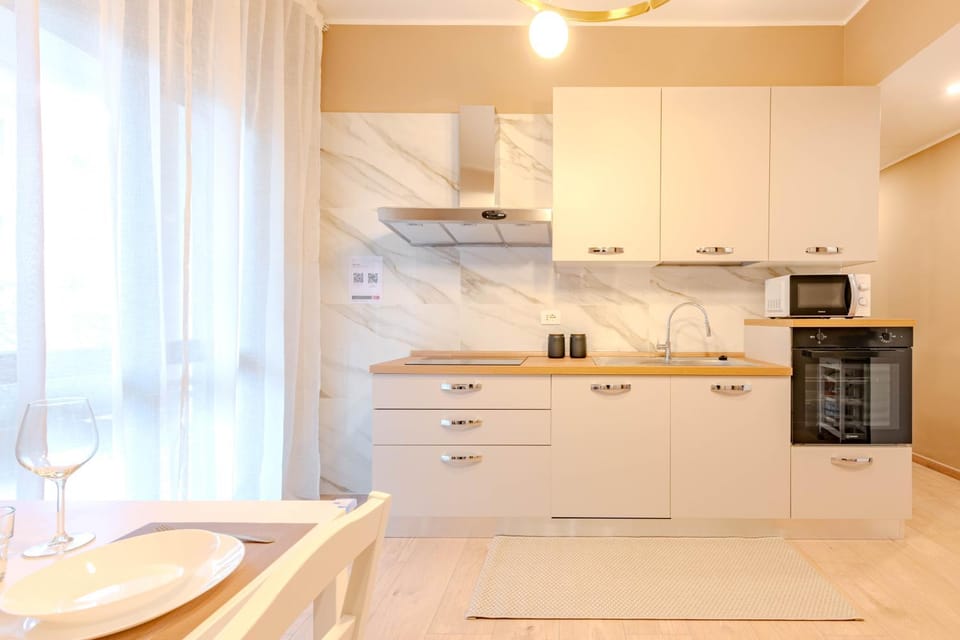 Kitchen or kitchenette, dishwasher, oven, stove