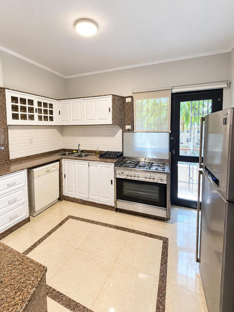 Kitchen or kitchenette, dishwasher, oven, stove