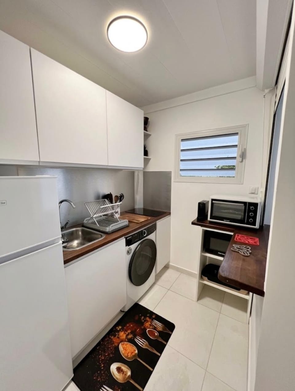 Kitchen or kitchenette, microwave, oven, stove, toaster, washing machine