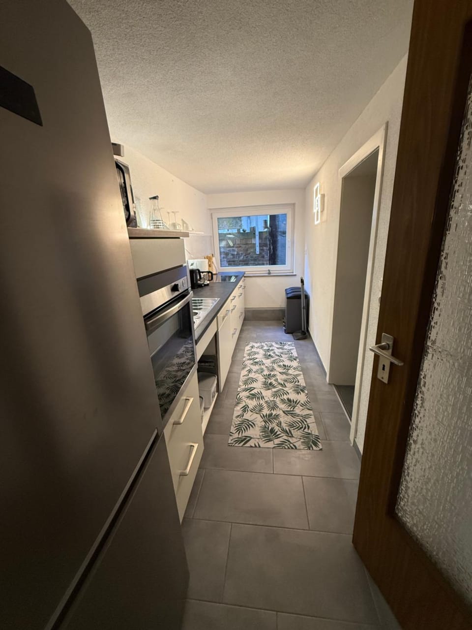 Kitchen or kitchenette, dishwasher, oven, stove