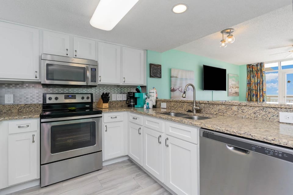 Kitchen or kitchenette, dishwasher, oven, stove
