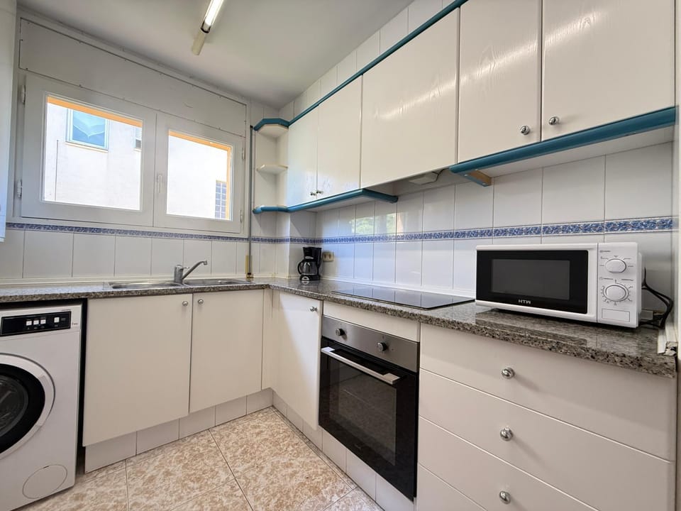 Kitchen or kitchenette, stove, washing machine