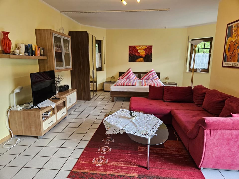 Bed, TV and multimedia, Living room, Seating area, Bedroom