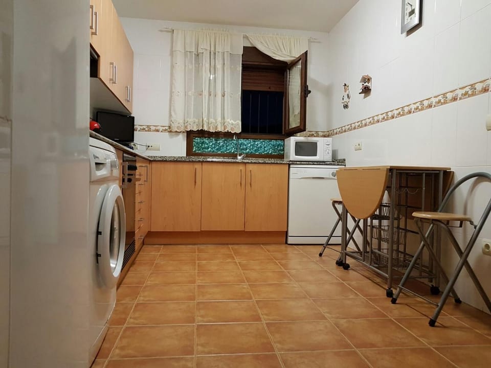 Kitchen or kitchenette, dishwasher, microwave, oven, stove, toaster, washing machine, kitchen