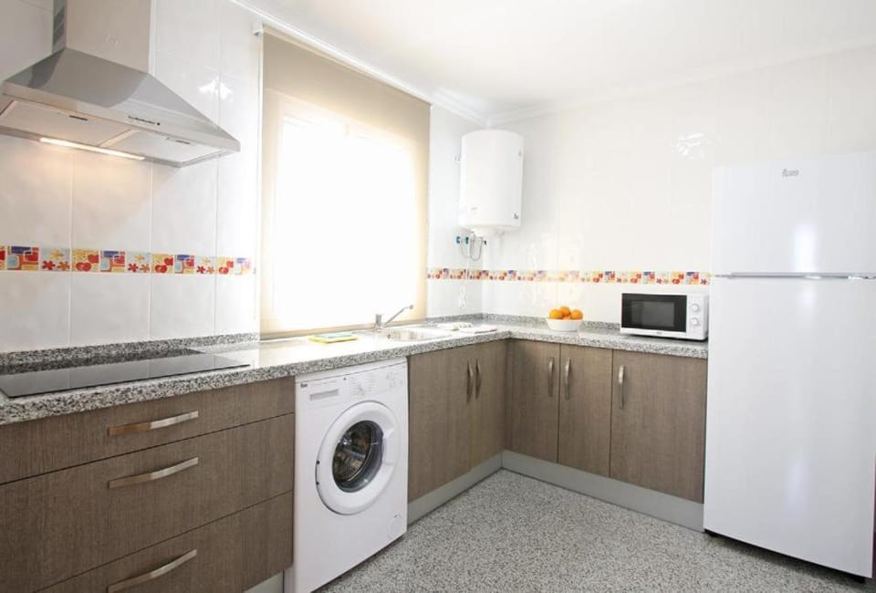 Kitchen or kitchenette, stove, toaster, washing machine