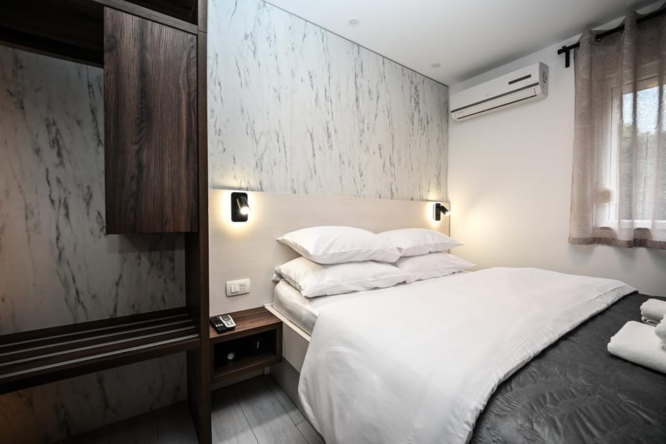 Bed, towels, wardrobe, air conditioner