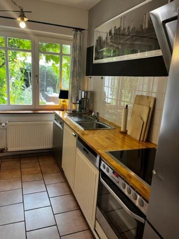Kitchen or kitchenette, dishwasher, oven, stove