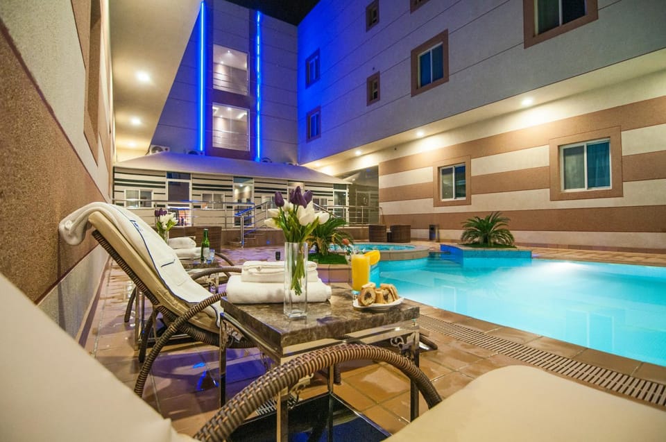 Property building, Facade/entrance, Decorative detail, Food, Pool view, Swimming pool, Entertainment, Drinks
