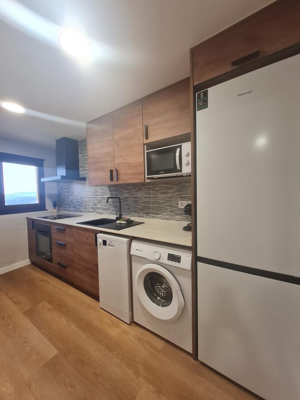 Kitchen or kitchenette, dishwasher, oven, stove, washing machine
