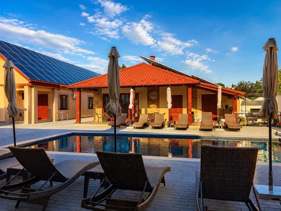 Property building, Patio, Pool view, Swimming pool, sunbed