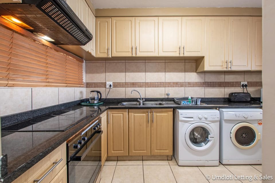 Kitchen or kitchenette, stove, washing machine, dryer
