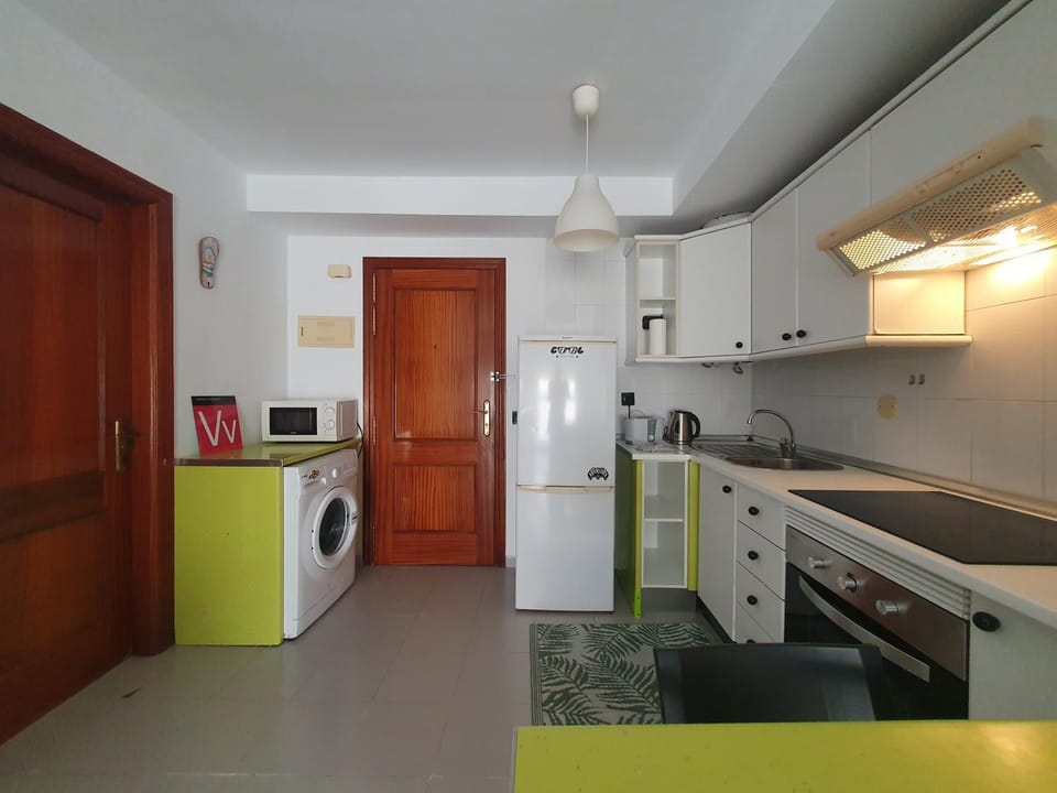 Kitchen or kitchenette, oven, stove, toaster, washing machine