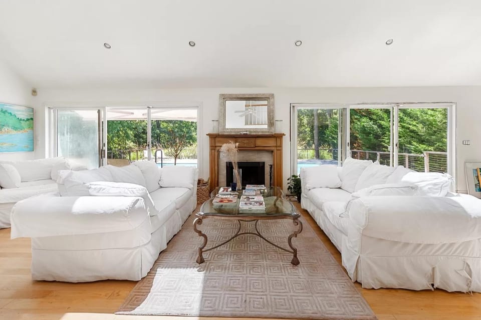 View (from property/room), Living room, Decorative detail, Seating area, Garden view, Pool view, fireplace