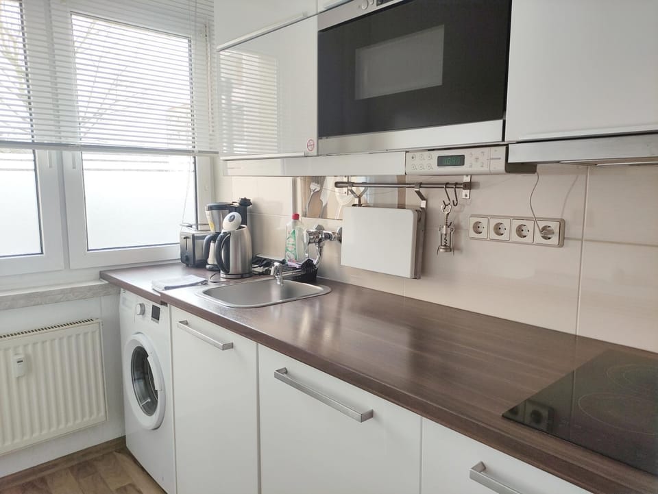 Kitchen or kitchenette, stove, toaster, washing machine