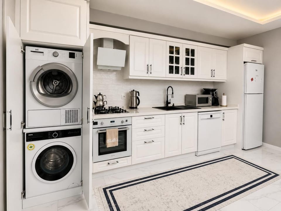 Kitchen or kitchenette, dishwasher, oven, stove, toaster, washing machine, dryer