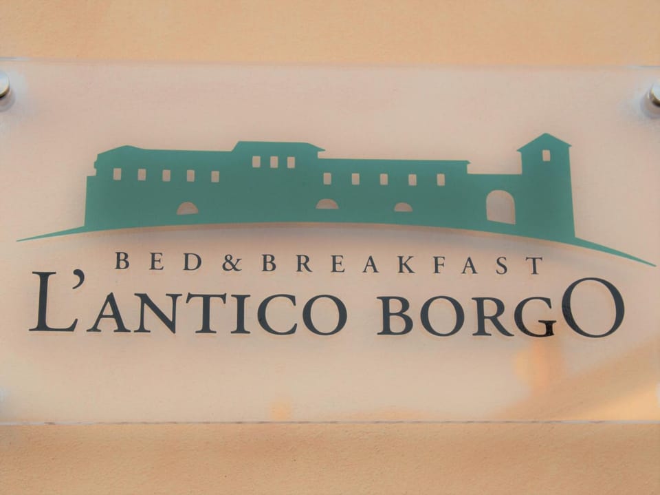 Property building, Facade/entrance, Property logo or sign, Natural landscape, Decorative detail