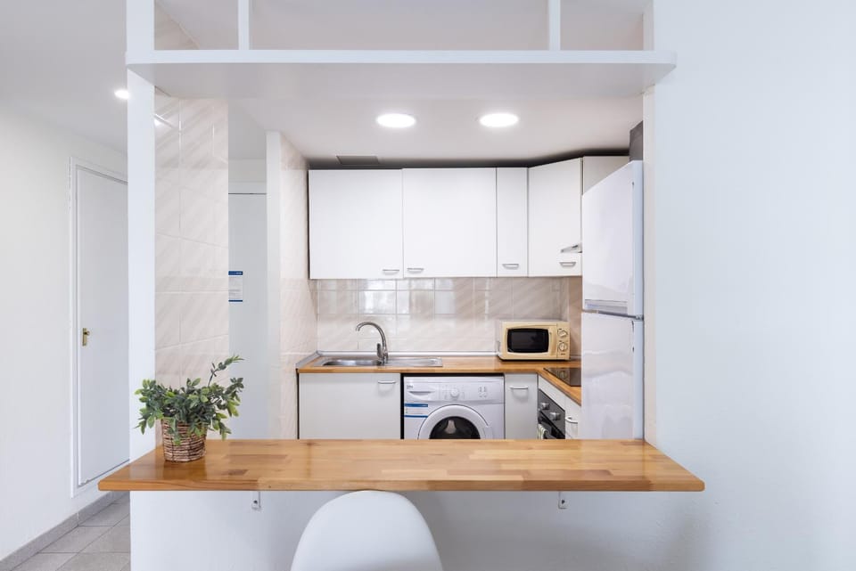 Kitchen or kitchenette, oven, stove, toaster, washing machine