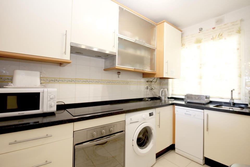 Kitchen or kitchenette, dishwasher, stove, washing machine