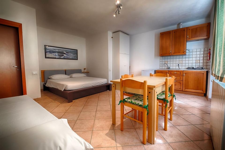 Bed, Kitchen or kitchenette, Seating area