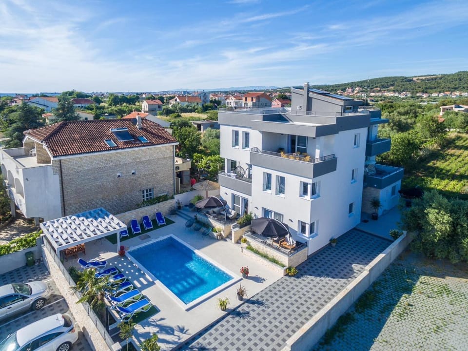 Property building, Patio, Day, Natural landscape, Bird's eye view, Pool view, Sea view, Swimming pool, sunbed
