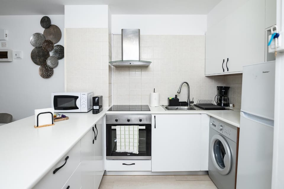 Kitchen or kitchenette, stove, toaster, washing machine