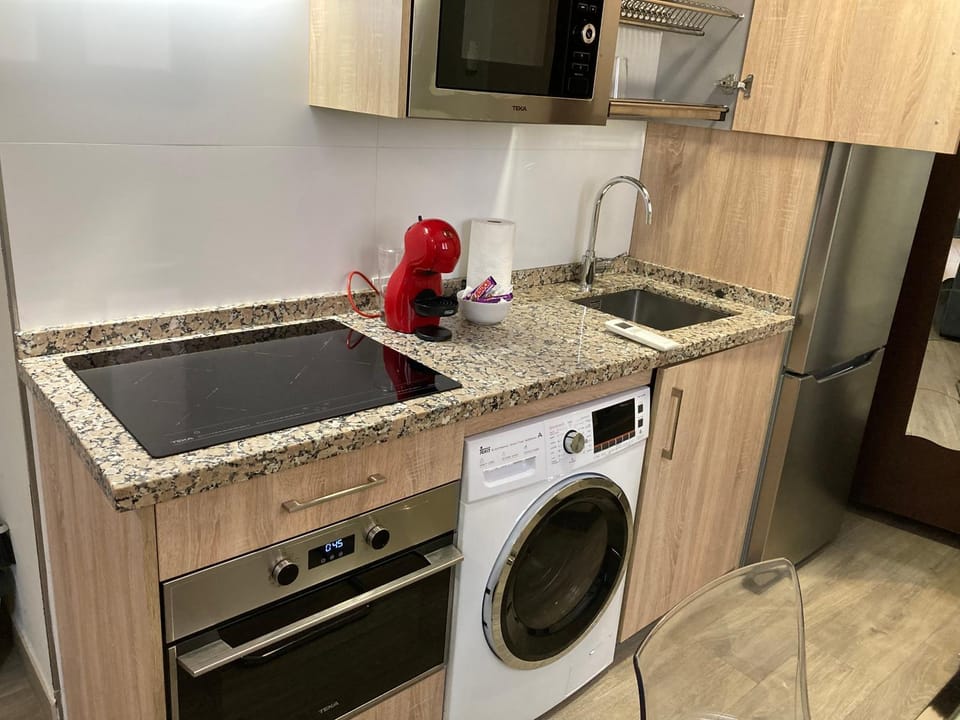 Kitchen or kitchenette, oven, stove, washing machine, dryer