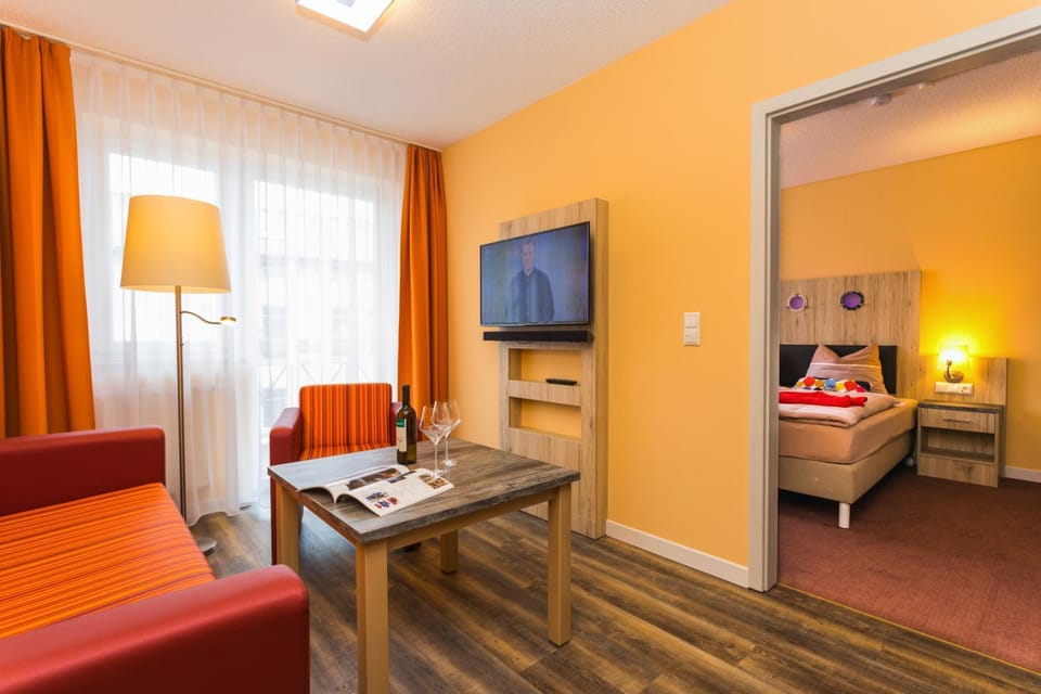 Bed, TV and multimedia, Living room, Seating area, Bedroom