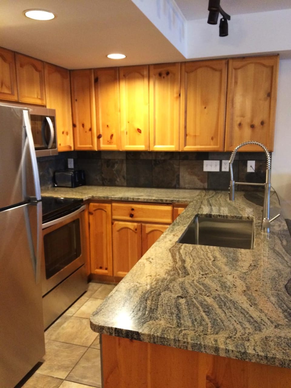 Kitchen or kitchenette, dishwasher, oven, stove, toaster
